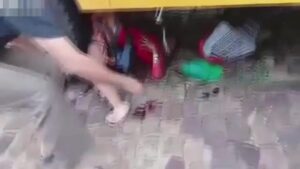 A lady with purchases was under the wheels of a bus