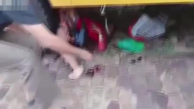 A lady with purchases was under the wheels of a bus