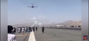 Afghans climb a plane and fall from the aircraft