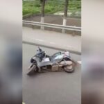 A lifeless aged guy looks out of under the steering wheel of a truck