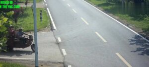 A motor-driven trike tip toes into a trailer