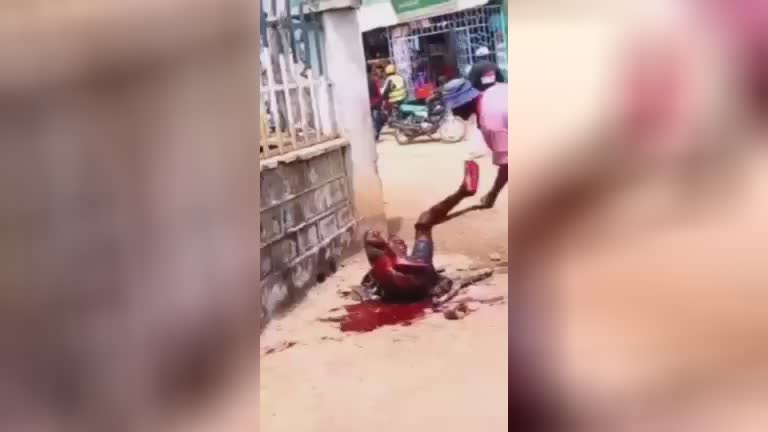 Guy attempts to stab a guy along with a machete in the center of the road