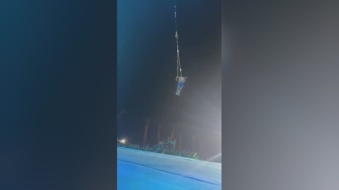 Beginner trapeze artist slips out of her partners grip