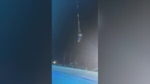 Beginner trapeze artist slips out of her partners grip