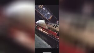 Truck moving fuselage strikes a pedestrian bridge