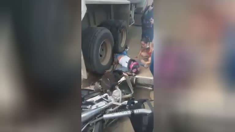 Woman motorcyclist crushed by truck wheels