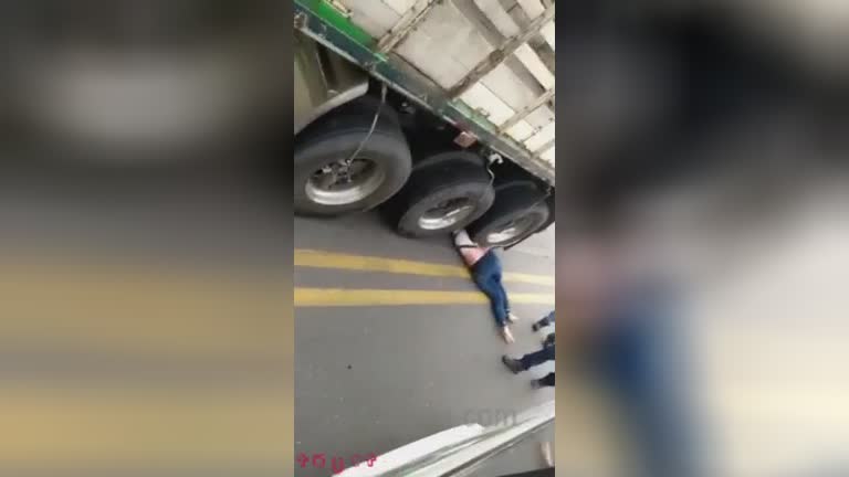 Female under the wheels of a truck