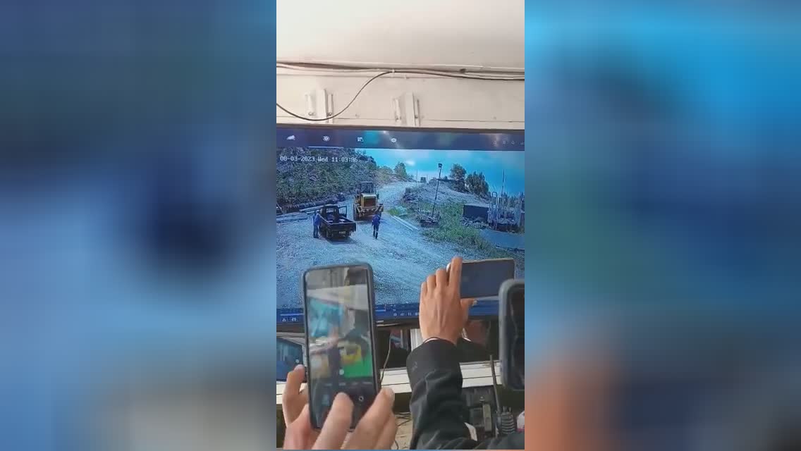 Pair of laborers acquiring gotten rid of through big front loading machine