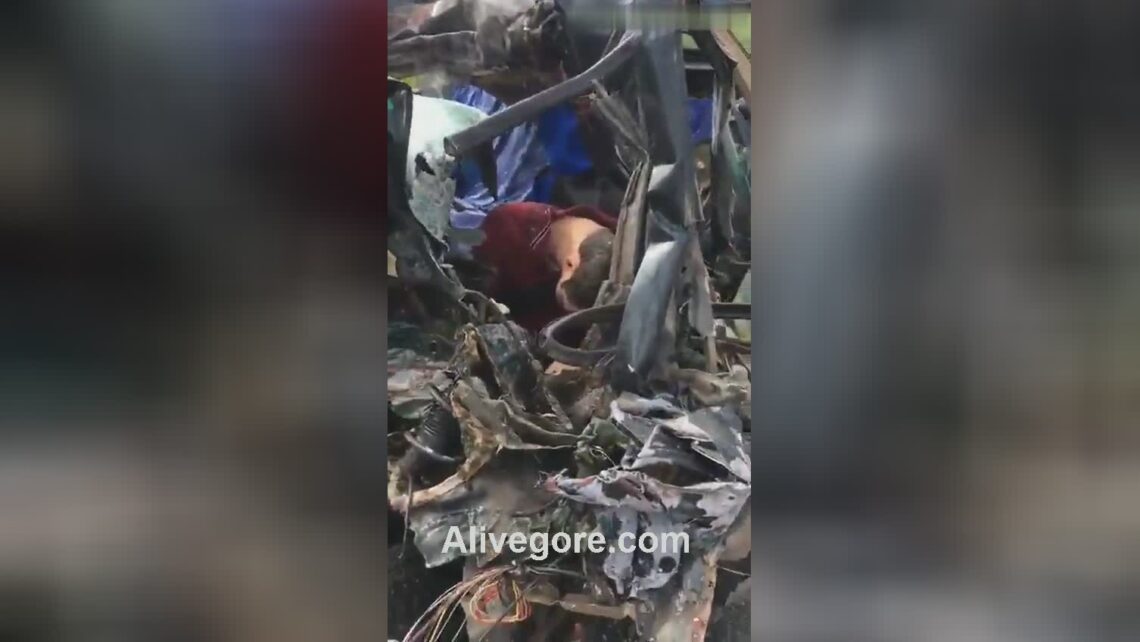 Two mutilated remains in a mangled cars and truck