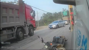 A Female Passenger On A Scooter Dive Under A Truck