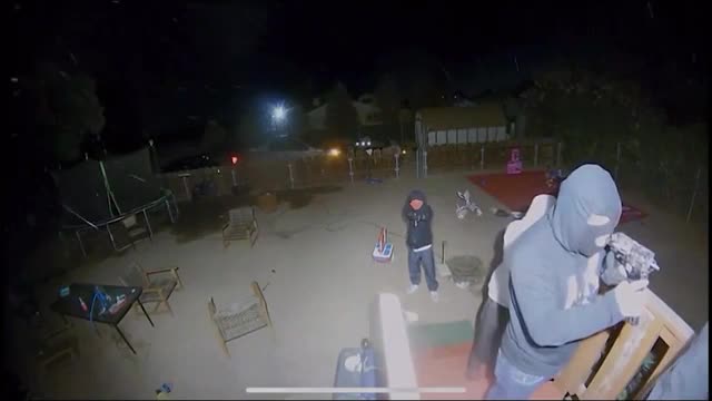 The crooks pushed the guy at gunpoint to open up the door