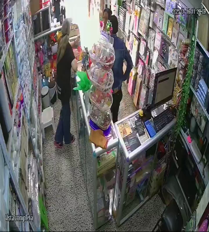 The Wife Was Distracting The Store Clerk While Her Husband Stole A Mobile Phone From Behind The Counter