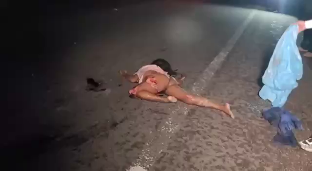 The Disfigured Body Of A Woman Shot Down By A Car. Cambodia